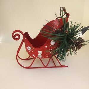 Sleigh red painted metal Christmas ornament with faux pine and decorations